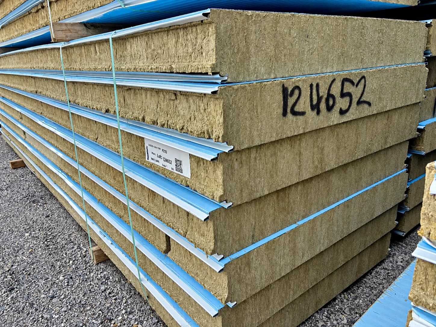 Close view of insulated panel edges staged in a supply yard